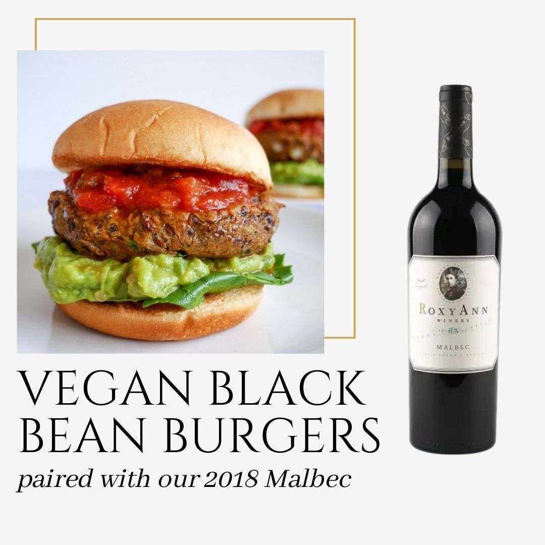 The image depicts a black bean burger topped with salsa, lettuce, and avocado and also shows a bottle of RoxyAnn 2018 Malbec. The caption on the graphic says "Vegan Black Bean Burgers paired with our 2018 Malbec." 