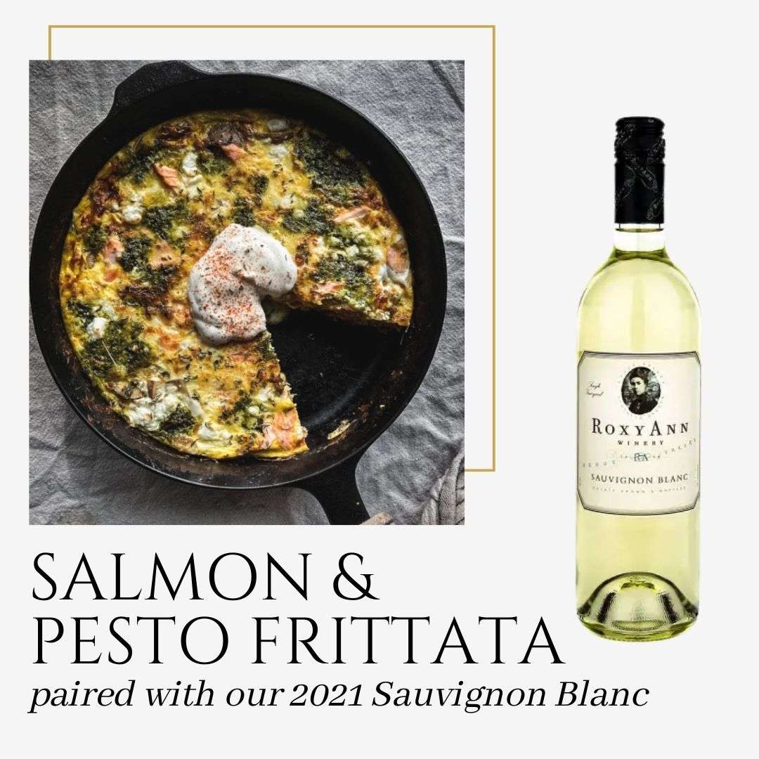 An image from Quick & Healthy Recipes And Their Wine Pairings by RoxyAnn Winery. The image depicts a salmon and pesto frittata in a cast iron skillet and also shows a bottle of RoxyAnn 2021 Sauvignon Blanc. The caption on the graphic says "Salmon and Pesto Frittata paired with our 2021 Sauvignon Blanc." 