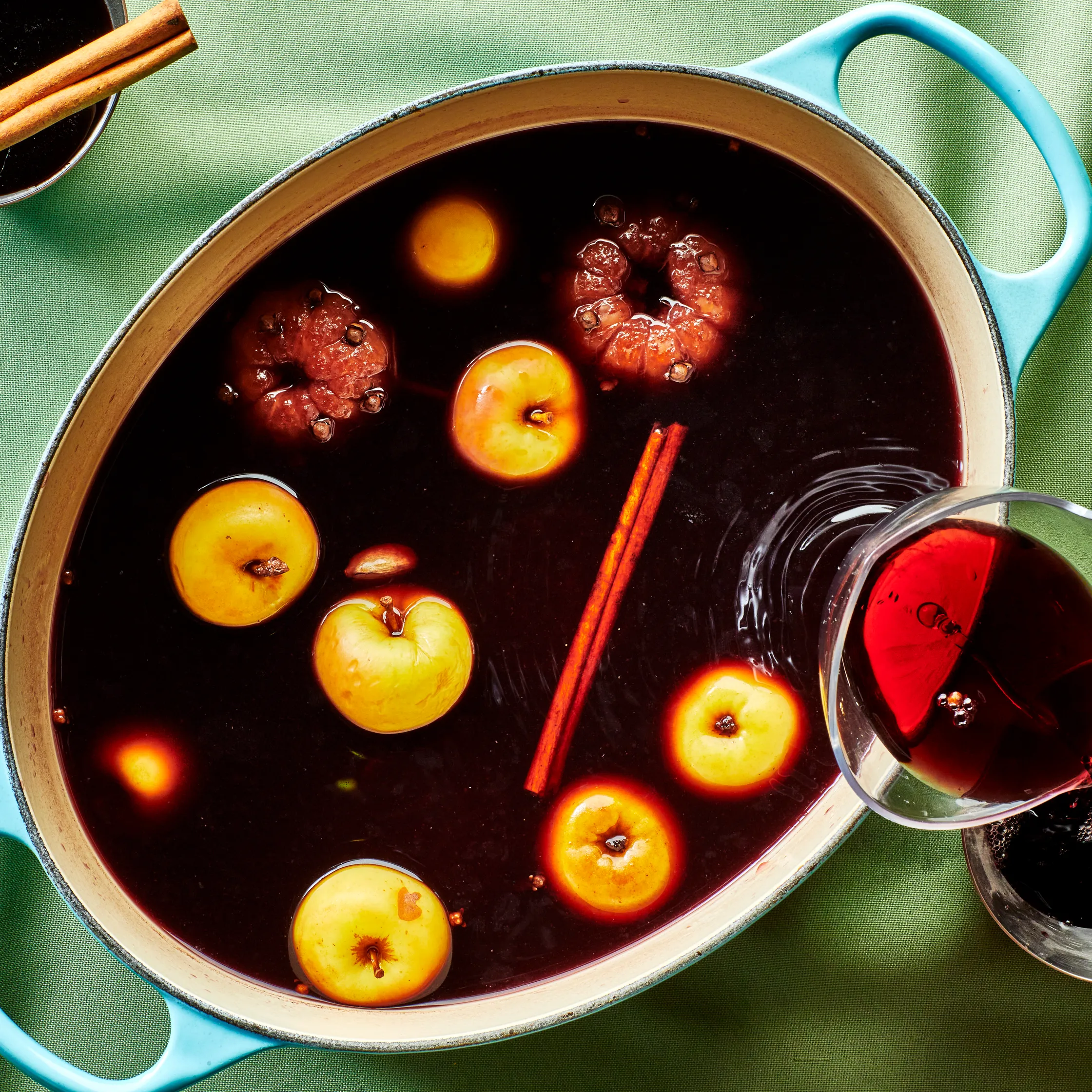 An image of a crockpot full of a fall wine cocktail drink, a mulled merlot from Bon Appétit.